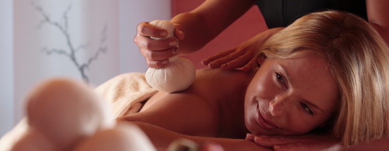 Woman get a sand stamp massage